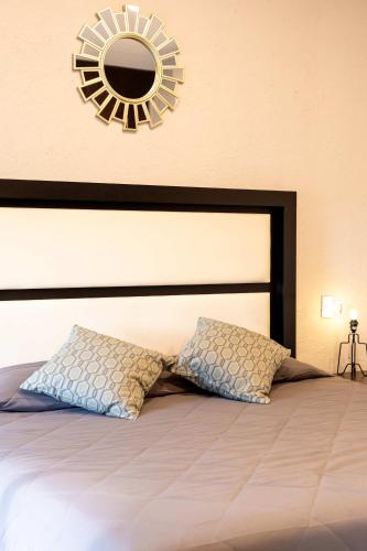 a bedroom with a large bed with a mirror on the wall at 304 Balcony apt Walk to Zocalo AC Rooftop in Mexico City