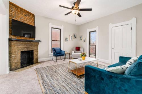 a living room with a blue couch and a fireplace at Entire Duplex - 2 Units in Milo