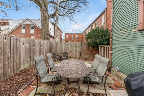 a patio with a table and chairs and a fence at Entire Duplex - 2 Units in Milo