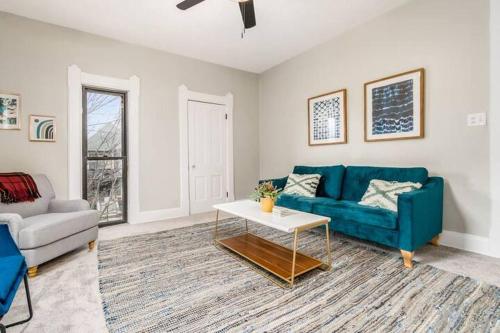 a living room with a blue couch and a table at Entire Duplex - 2 Units in Milo