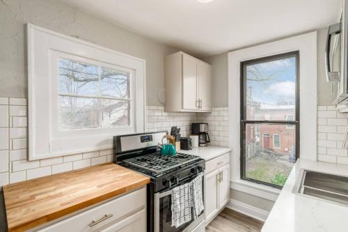 a kitchen with a stove top oven next to a window at Entire Duplex - 2 Units in Milo