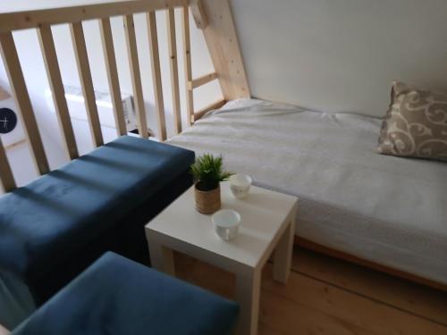 a bedroom with a bed and a table with a plant on it at Vila SVITAC Banja Vrujci in Mionica