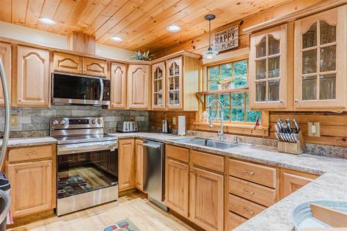 a kitchen with wooden cabinets and stainless steel appliances at Wally`s Kabin in Whittier