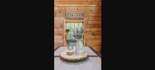 a room with a table and a sign that reads home at Wally`s Kabin in Whittier