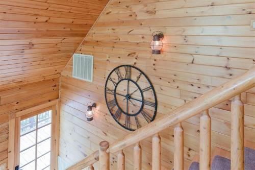 a spiral staircase in a log cabin with a clock at Wally`s Kabin in Whittier