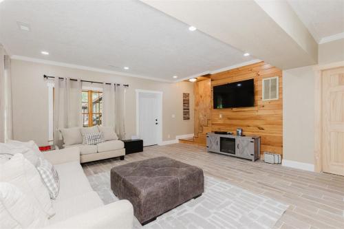 a living room with a white couch and a tv at Wally`s Kabin in Whittier