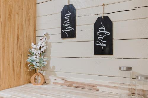 a room with two signs hanging on a wall at Wally`s Kabin in Whittier