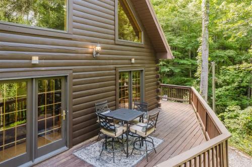 a wooden deck with a table and chairs on it at Wally`s Kabin in Whittier