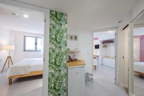 a bedroom with a bed and a room with a door leading to a bedroom at Banana Garden La Palma in Santa Cruz de la Palma