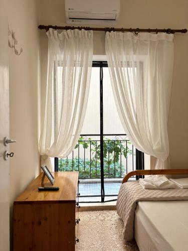 a bedroom with a bed and a large window at Ναϊάδες in Konístrai