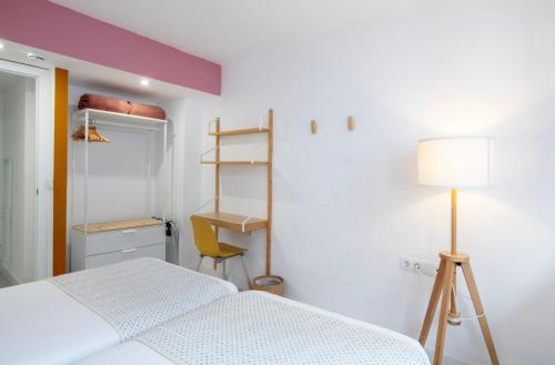 a bedroom with a bed and a desk and a lamp at Banana Garden La Palma in Santa Cruz de la Palma