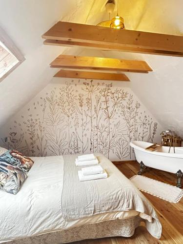 a bedroom with a bed and a sink and a tub at Szumidomki strefa z jacuzzi sauna widok na potok las in Zawoja