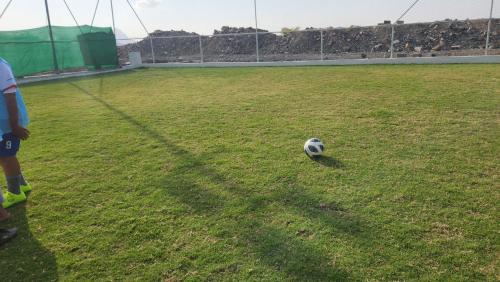 a soccer ball sitting on a soccer field at غرف البونسيانا in Bahlāʼ