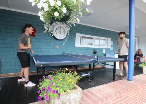 two men standing around a ping pong table at The Janmere Motel in Hampton