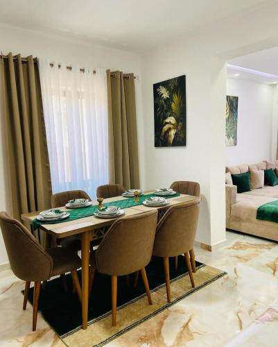 a dining room table and chairs in a living room at Karadag in Ulcinj