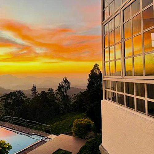 a building with a painting of a sunset at The Colonial Crest in Nillambe