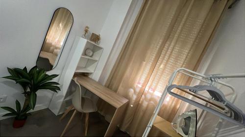 a bathroom with a sink and a mirror next to a window at Villa potasa 19 in Madrid