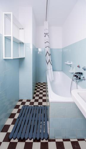 a blue bathroom with a tub and a sink at Almádi64 in Balatonalmádi