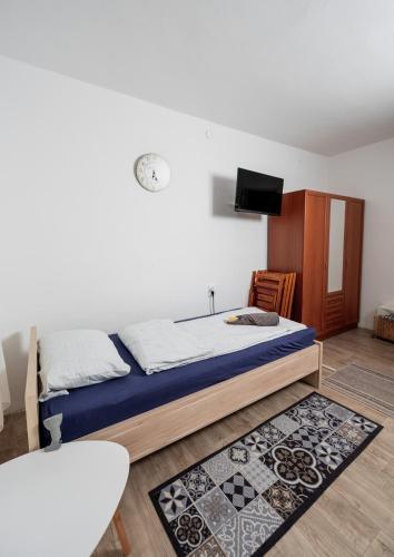 a bedroom with a bed and a flat screen tv at Almádi64 in Balatonalmádi