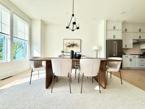 a dining room with a table and chairs at Executive 3BR Townhome Rooftop & Elevator Near Avalon in Alpharetta