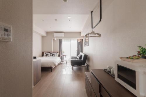 a hotel room with a bed and a living room at LANG HOTEL Kameido - Vacation STAY 76905v in Tokyo
