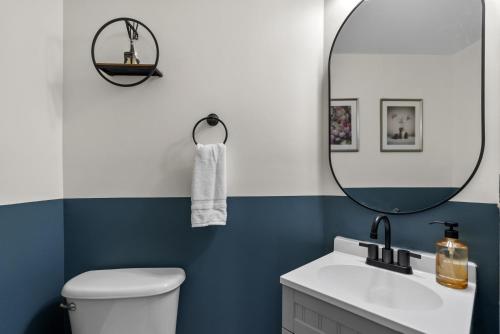 a bathroom with a white toilet and a mirror at Family friendly single house Close to Washington DC in Woodbridge