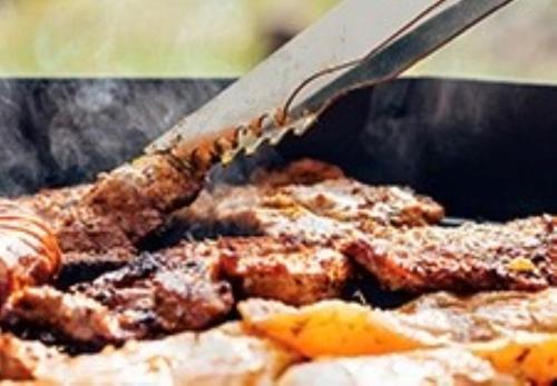 a spatula cooking food on top of a grill at Riverside Glamping Nuts - Vacation STAY 78072v in Yamakami