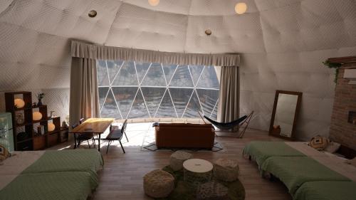 a room with two beds and a large window at Riverside Glamping Nuts - Vacation STAY 78071v in Yamakami