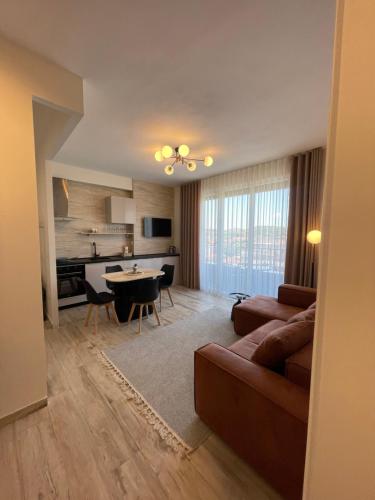 a living room with a couch and a table at Class Elite Apartment in Shkodër