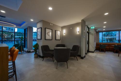 a waiting area in a hospital with chairs and tables at Holiday Inn & Suites Winnipeg Downtown by IHG in Winnipeg