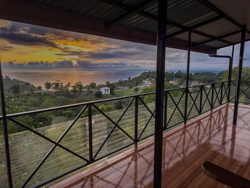 a room with a view of the water at Pura Natura Lodge Manuel Antonio in Manuel Antonio