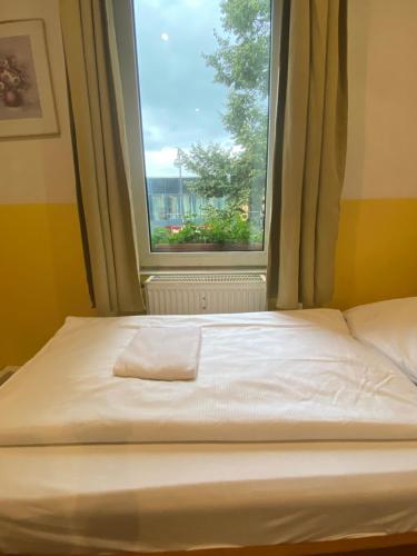 a bed in a room with a window at A&S FerienwohnungenBonner str 49 in Bonn