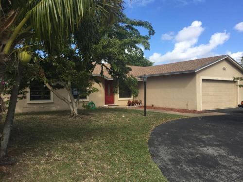 a house with a palm tree in front of it at 82-10SW 135AV in Miami