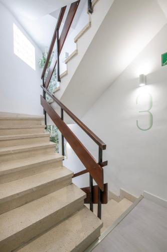 a staircase in a house with wooden railings at Banana Garden La Palma in Santa Cruz de la Palma
