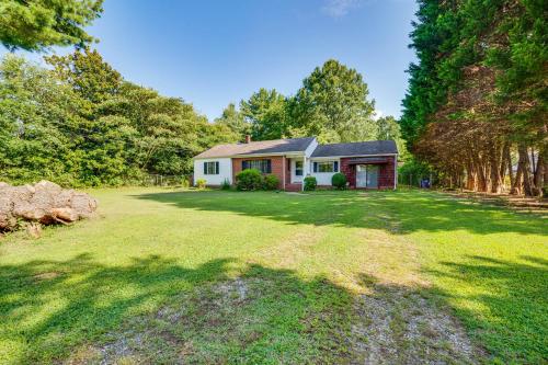 a home with a large yard with a house at Winston-Salem Home on 2 Acres - Spacious Deck! in Winston-Salem