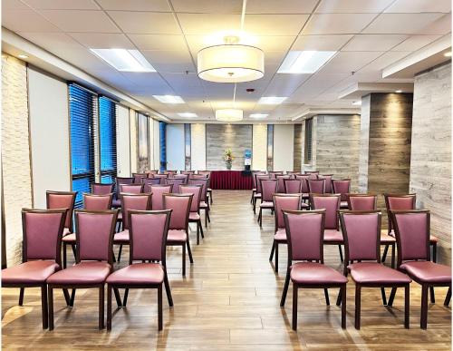 a conference room with purple chairs and a podium at Holiday Inn Newark International Airport in Newark