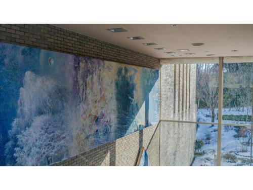 a large painting on the wall of a room with a window at Ouka no sato La-Foret Shobara - Vacation STAY 67406v in Shōbara