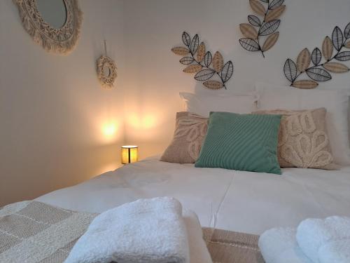 a bedroom with a white bed with a green pillow at La Bohème, Studio, Proche Gare SNCF, Netflix in Laval