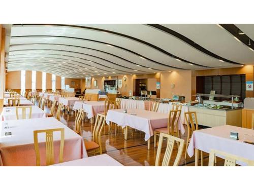 a dining room with white tables and chairs at Ouka no sato La-Foret Shobara - Vacation STAY 67406v in Shōbara