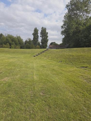 a grassy field with a path in the middle of it at Pet Haven Humberston Fitties Cleethropes Lincolnshire in Humberston