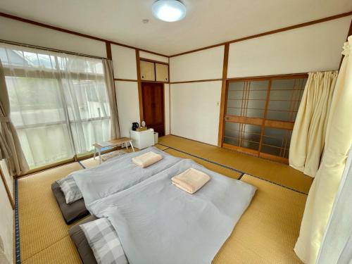 a bedroom with two beds and a window at Kaen - Vacation STAY 19037 in Aso