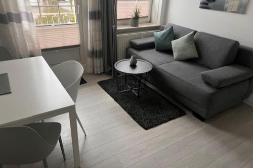 a living room with a couch and a table at Nordsee 04 in Cuxhaven