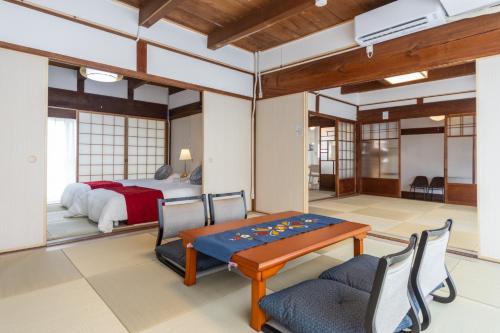 a bedroom with a bed and a table and chairs at Yokkaichi - House - Vacation STAY 19181 in Yokkaichi