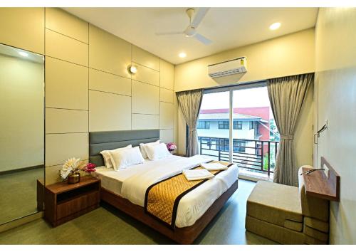 a bedroom with a bed and a large window at Sukoon by PEP stays in Lonavala