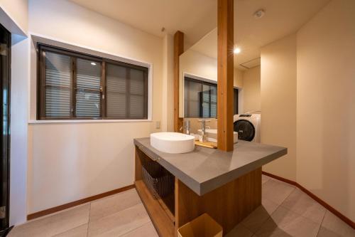 a bathroom with a sink and a mirror at Villa Mille - Vacation STAY 19589 in Ito