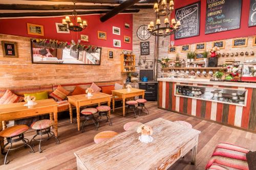 a restaurant with tables and chairs and a bar at Sonesta Posadas del Inca - Valle Sagrado Yucay Urubamba in Urubamba