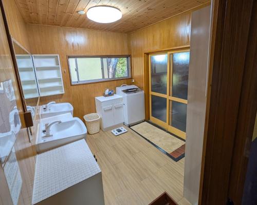 a bathroom with two sinks and a washer and dryer at Nasu Green Onsen - Vacation STAY 19256 in Nasu-yumoto