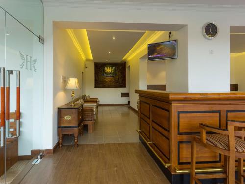 a hallway with a waiting room with a table and chairs at Heaven Seven Kandy in Kandy