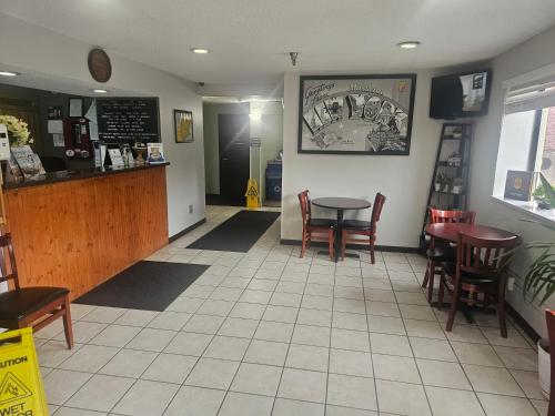 a dining room with a table and chairs in a restaurant at Super 8 by Wyndham Massena NY in Massena