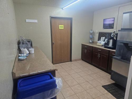 a kitchen with a counter and a door in a room at Super 8 by Wyndham Massena NY in Massena